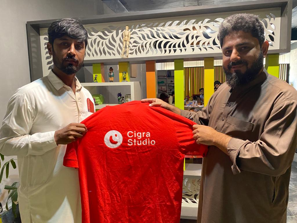 cigra studio is giving a shirt to his employee